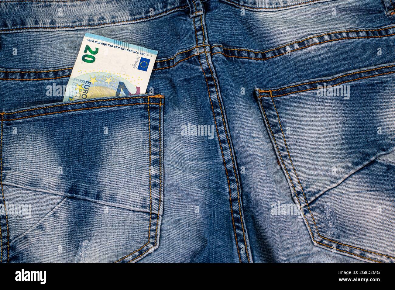 20 euros that come out of the pocket of blue jeans Stock Photo