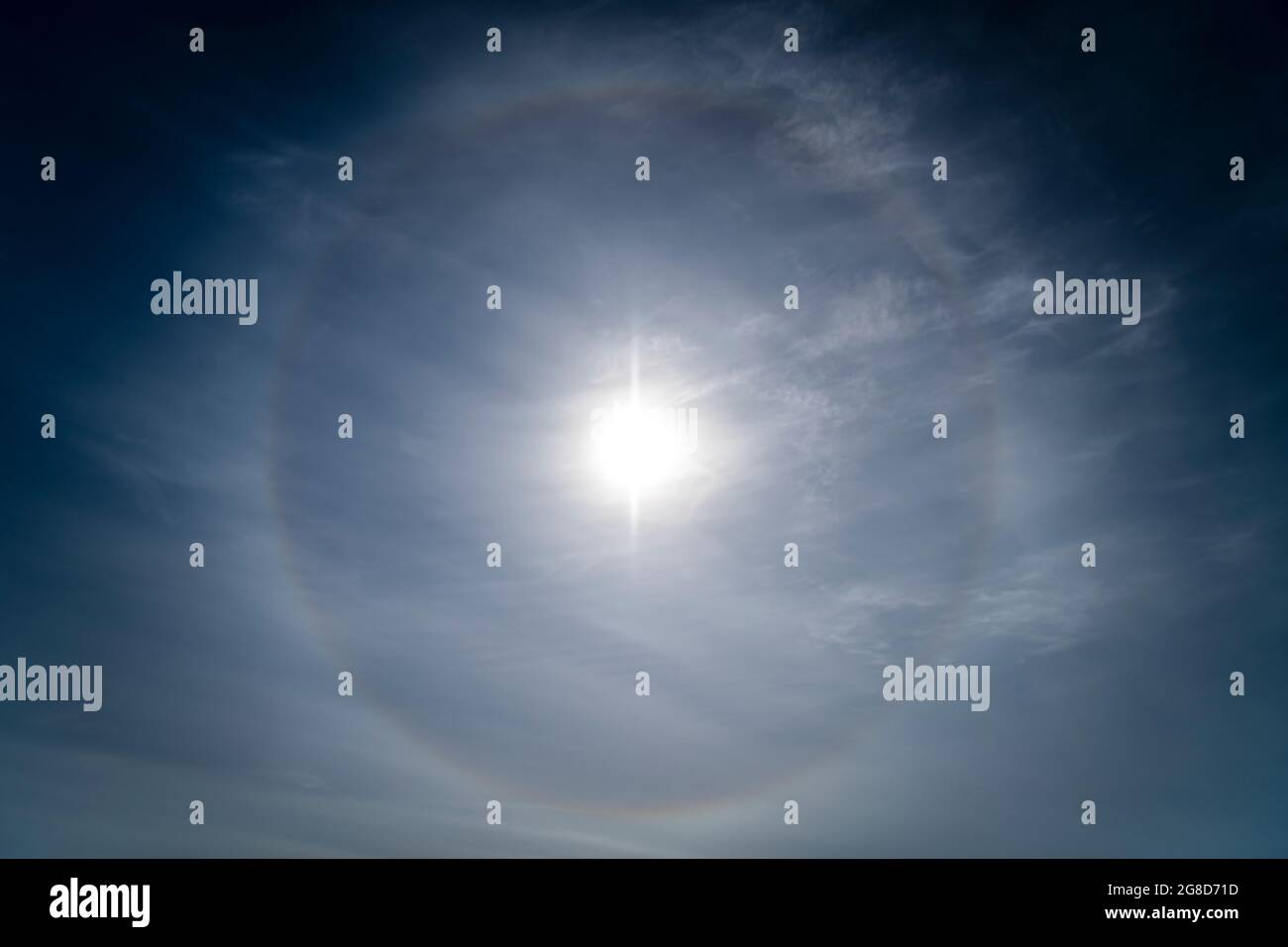 A 3 shot HDR image of a Sun Halo or 22 Degree Halo, an Atmospheric phenomena caused by ice crystals refracting light in Cirrus clouds, Scotland. Stock Photo