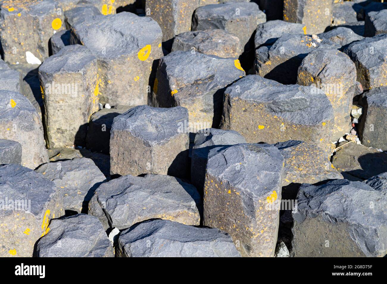 The photo shows massive stone blocks of a bank protection Stock Photo