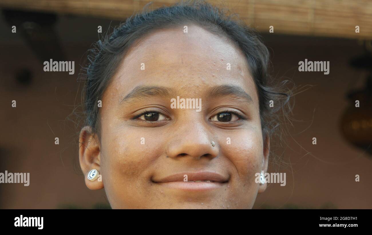 Portrait of a young smiling Indian female with earrings and a nose piercing Stock Photo
