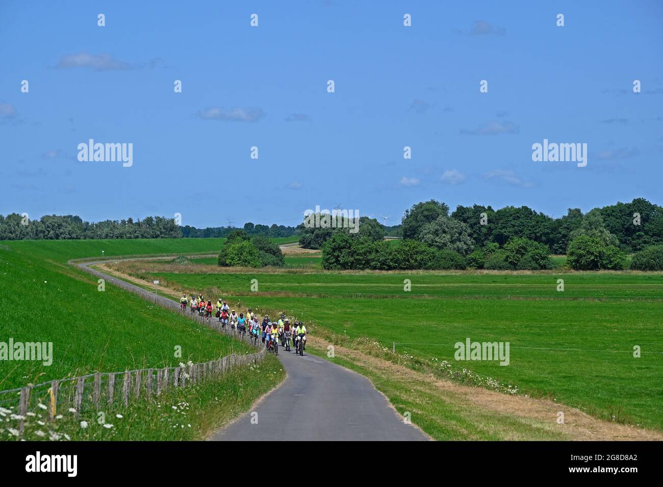 papenburg, germany -  2021-07-17: a group of cyclists including disabled / handicapped people touring along the banks of river ems  --  [credit: joach Stock Photo