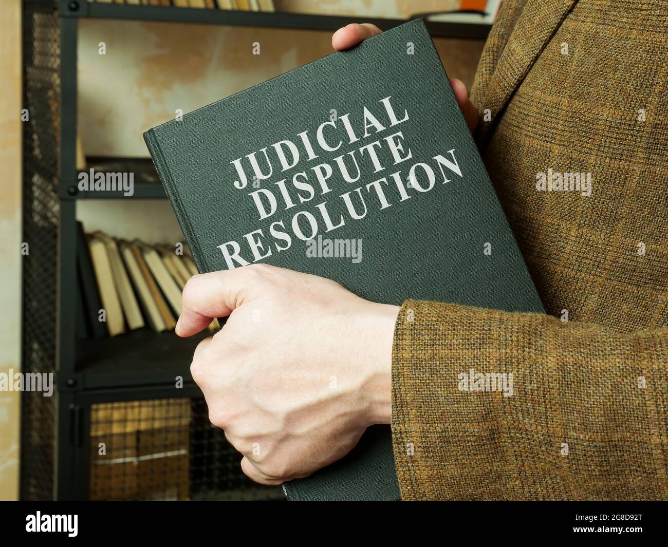 Man shows judicial dispute resolution JDR book. Stock Photo