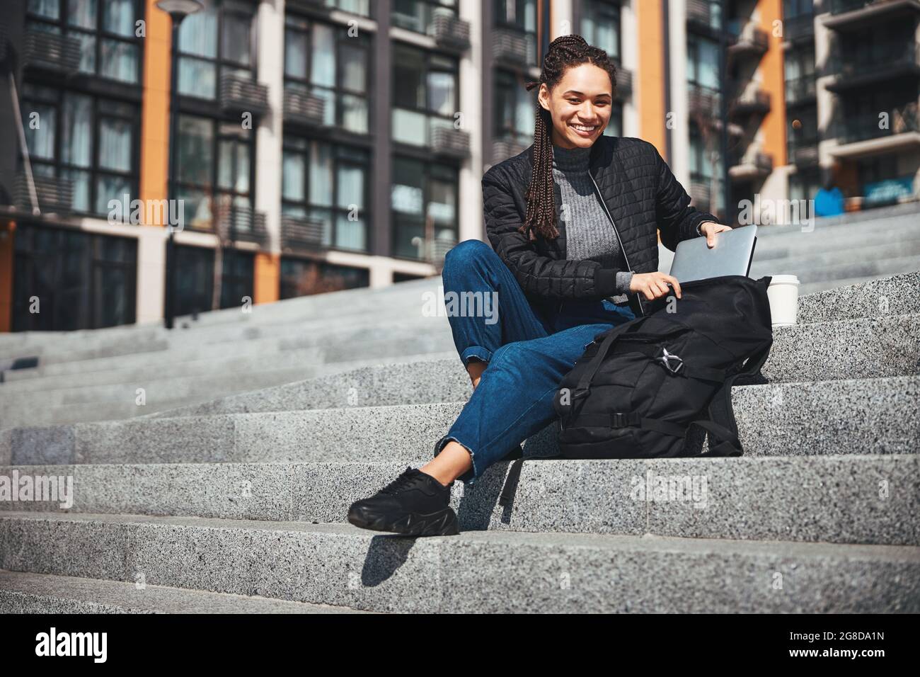High-spirited good-looking lady reaching for her laptop Stock Photo