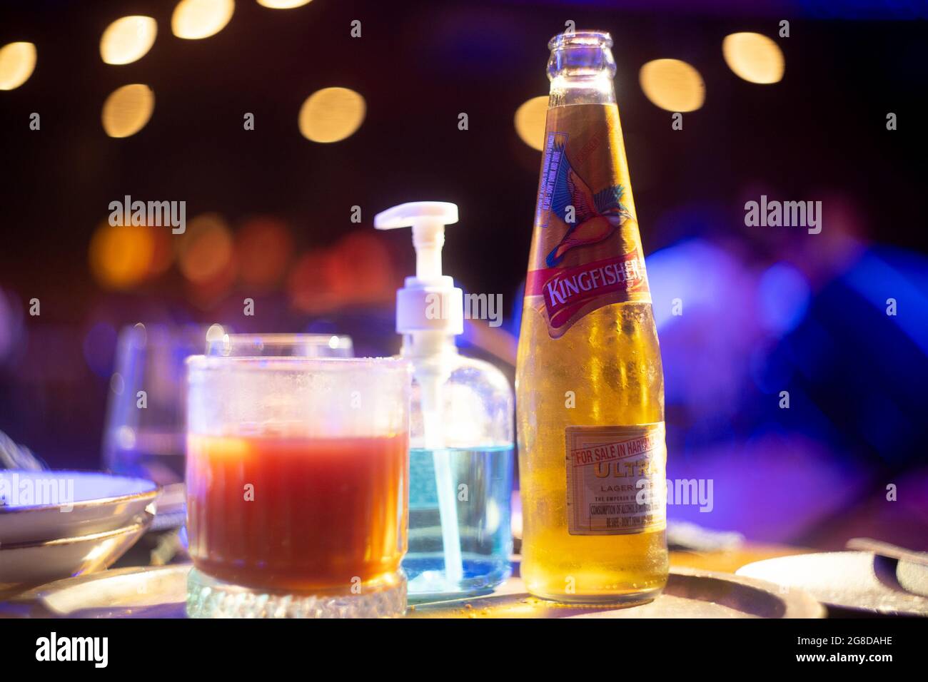 Gurgaon, Delhi, India - circa 2021 : famous indian beer brand kingfisher bottle with bubble coming out with out of focus background lights with bokeh Stock Photo