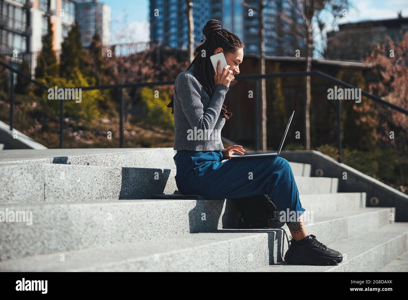 African woman sitting alone side view hi-res stock photography and ...