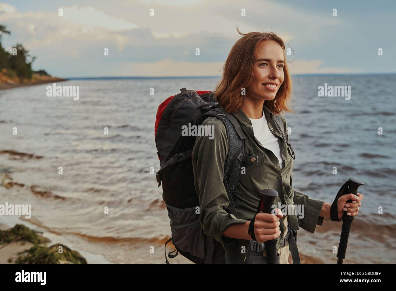 Positive tourist staring forward while doing Nordic walking Stock Photo