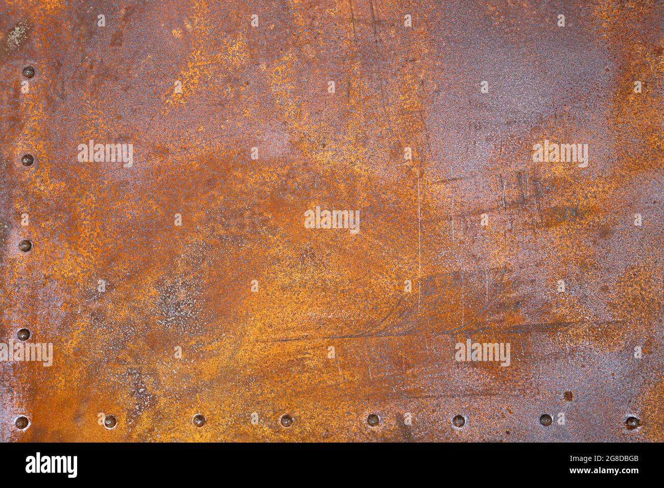 rusty iron texture. Rustic iron plate with rivets. Stock Photo