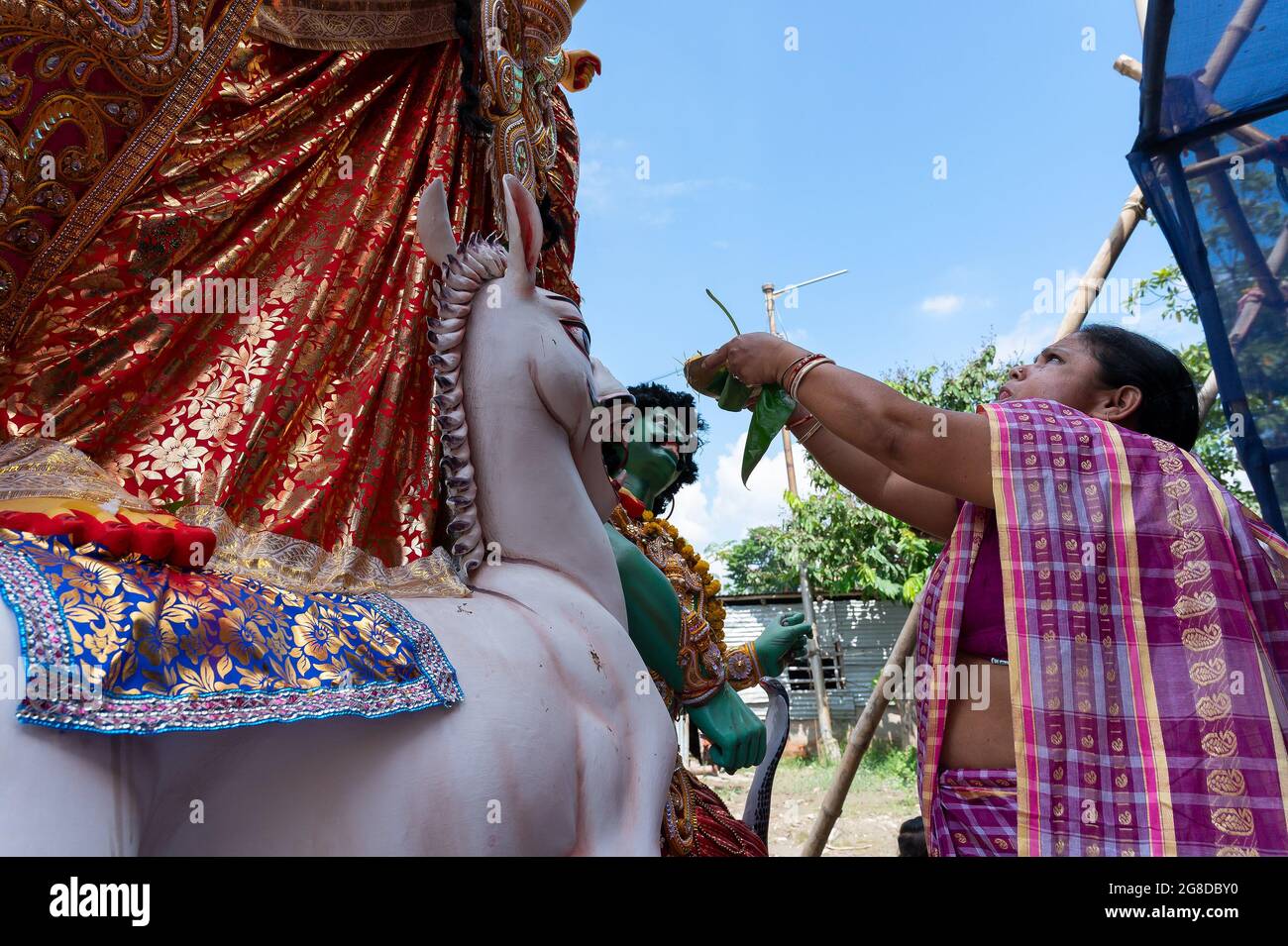 Howrah, West Bengal, India- 8th October 2019 : Vijayadashami, married Bengali Hindu woman offering sweets to Goddess Durga and praying to Her. Durga p Stock Photo