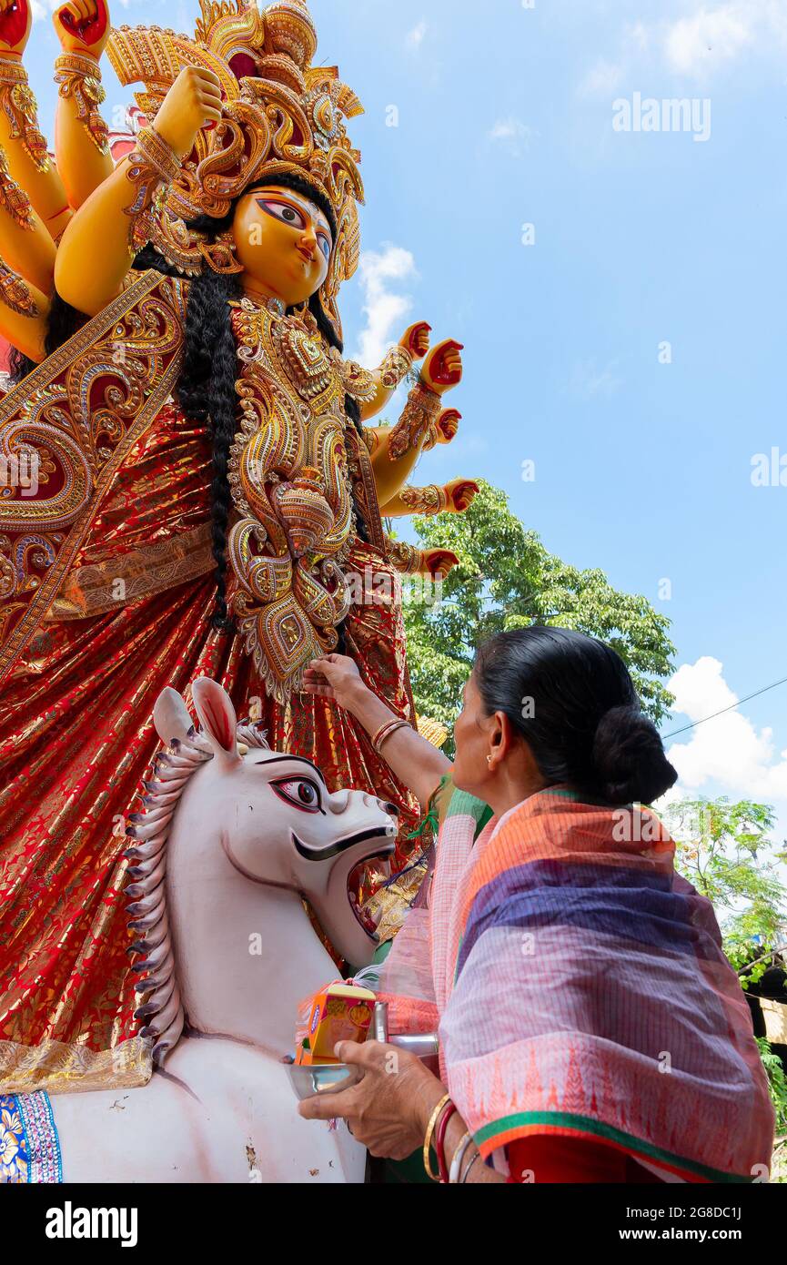 Howrah, West Bengal, India- 8th October 2019 : Vijayadashami, married Bengali Hindu woman offering sweets to Goddess Durga and praying to Her. Durga p Stock Photo