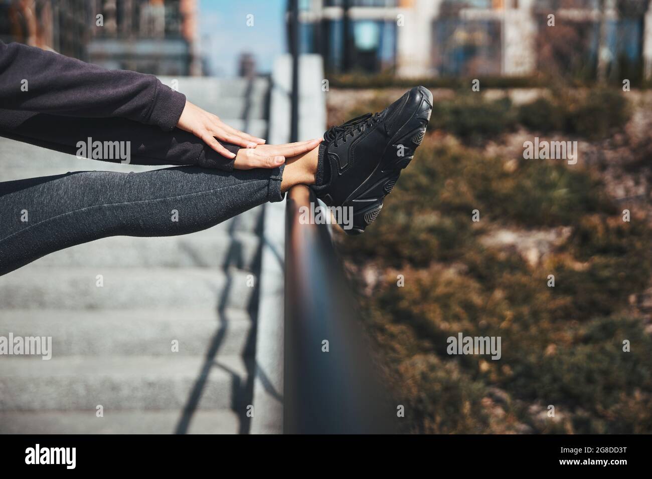 Flexible athlete doing a stretching exercise in a standing position Stock Photo