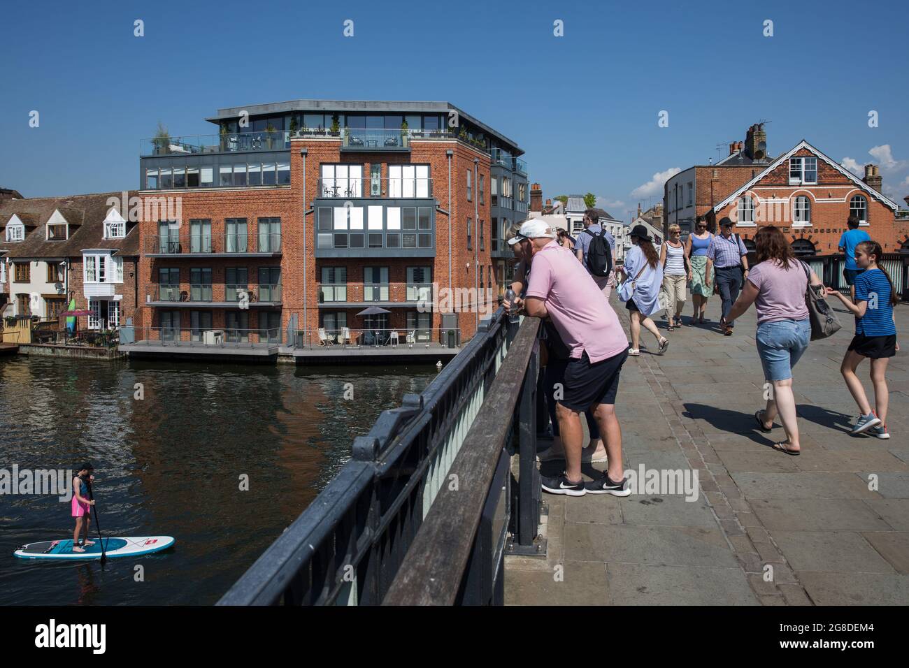 Windsor, UK. 19th July, 2021. Members of the public watch paddle boarders on the River Thames from Windsor bridge on 'Freedom Day', when the UK government lifted almost all remaining Covid-19 restrictions in England. Social distancing restrictions have been removed and face coverings are no longer required by law, although their use is recommended in crowded and enclosed spaces. Credit: Mark Kerrison/Alamy Live News Stock Photo