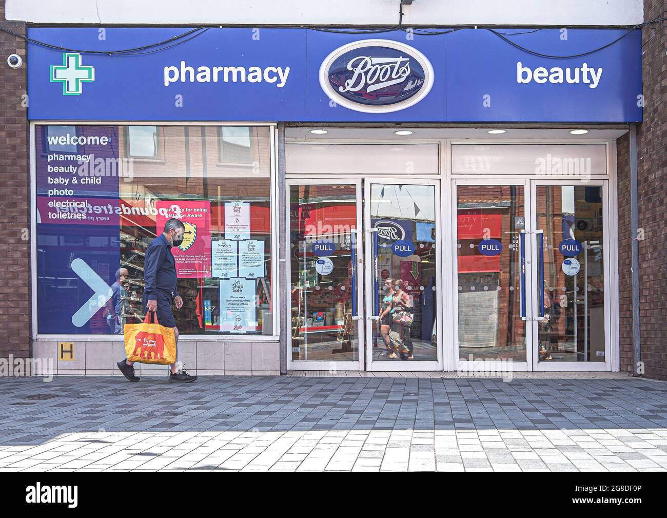 Lisburn, UK. 19th July, 2021. Shopper walks by Boots Pharmacy on Bow  Street. (Credit Image: © Michael Mcnerney/SOPA Images via ZUMA Press Wire  Stock Photo - Alamy