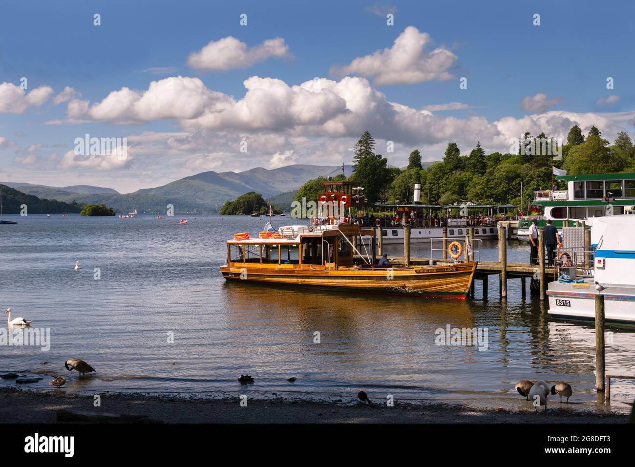 WINDERMERE, ENGLAND - JULY 5th, 2021: wooden boat on windermere on a beautiful summer afternoon, Lake district, England Stock Photo
