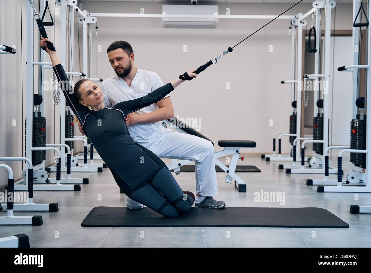 Patient woman doing exercises for recovery arms after injury using