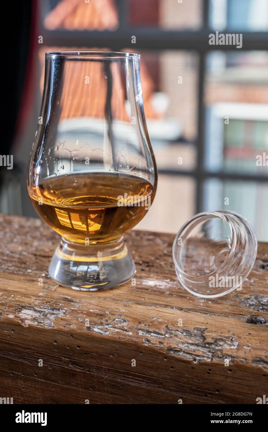 Dram of single malt scotch whisky served in tasting glass with view on old  window and houses on wooden beam Stock Photo - Alamy