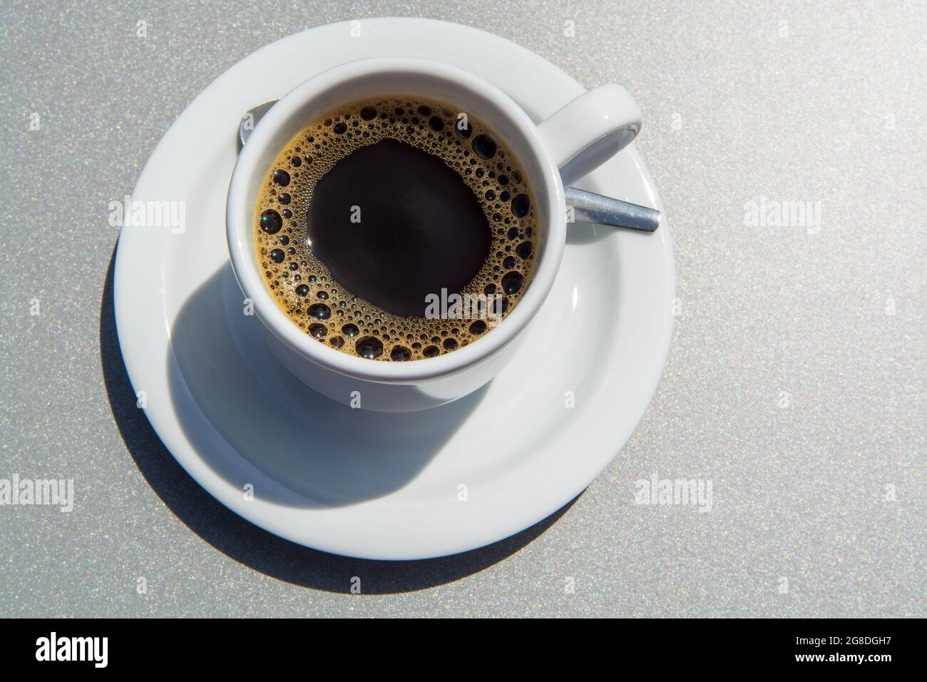 White cup of black coffie on gray background close up Stock Photo