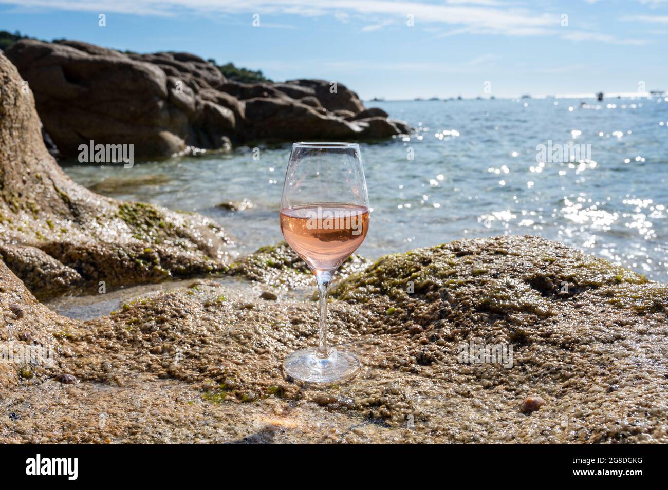 Summer time in Provence, glass of cold rose wine on sandy beach near Saint-Tropez in sunny day, Var department, France Stock Photo