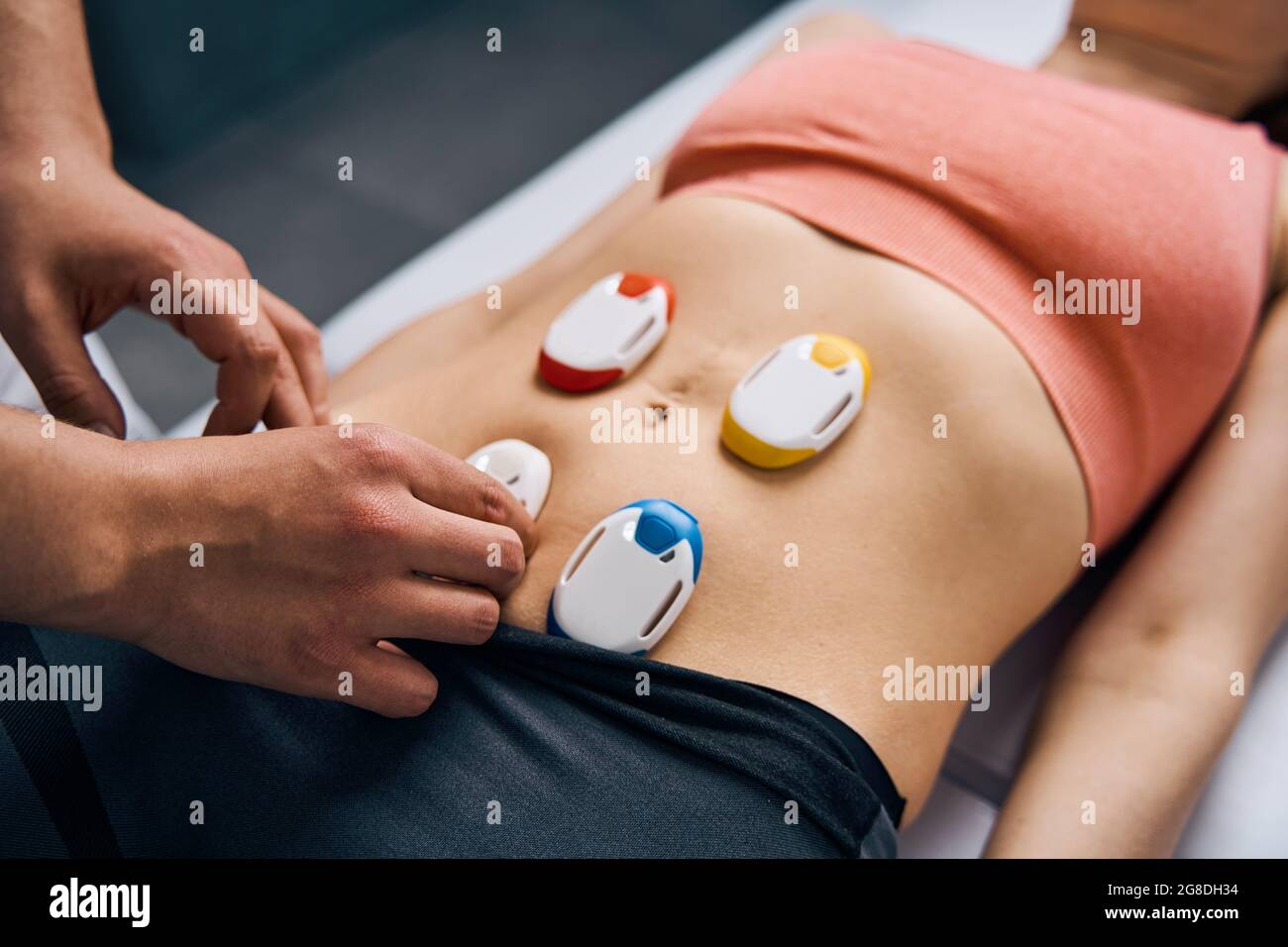 https://c8.alamy.com/comp/2G8DH34/close-up-of-electric-stimulator-on-woman-stomach-physiotherapy-electrodes-for-myostimulation-2G8DH34.jpg