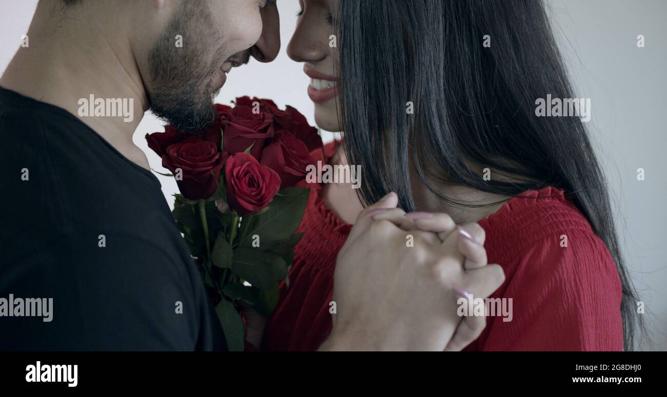 Young Indian couple holding hands and looking at each other with loving facial expression Stock Photo