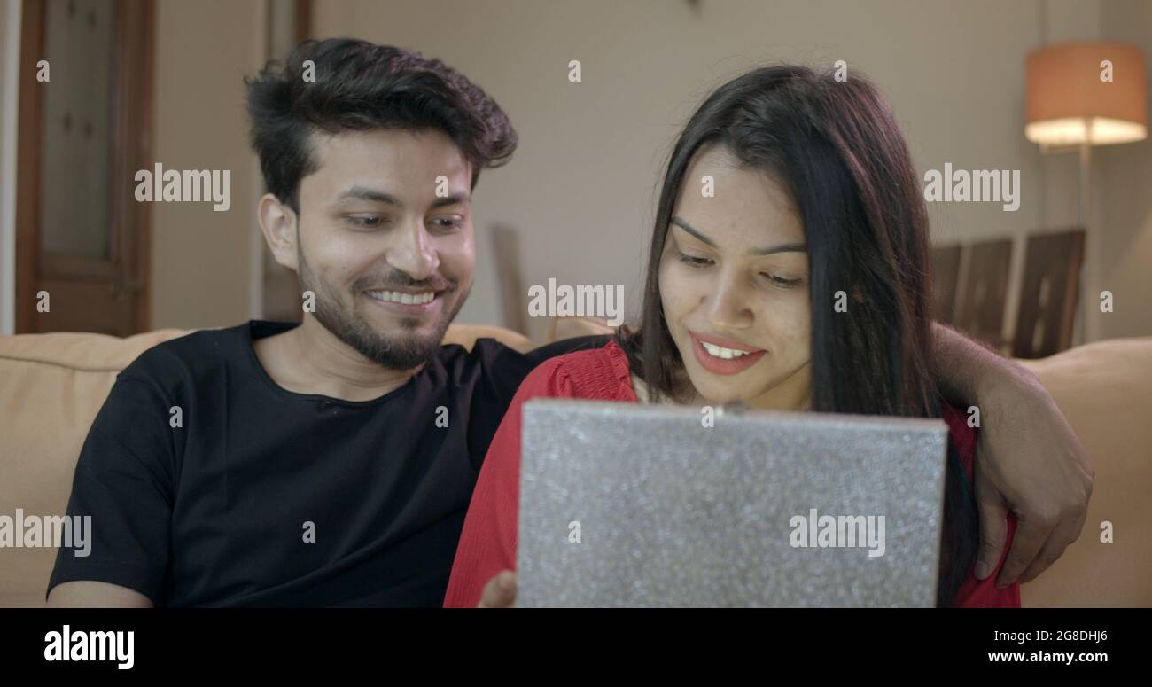 Indian young couple sitting together hi-res stock photography and ...