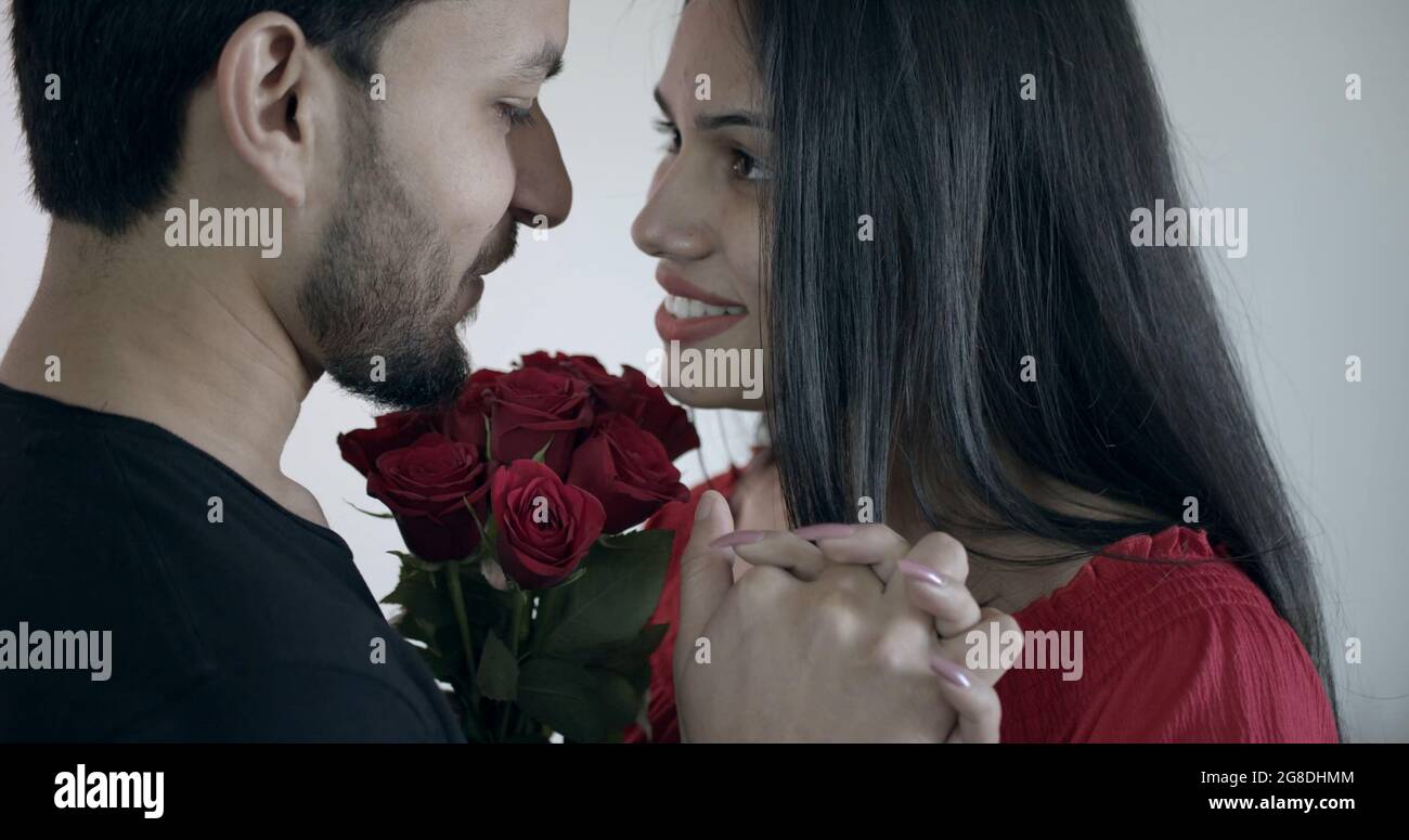 Young Indian couple holding hands and looking at each other with loving ...