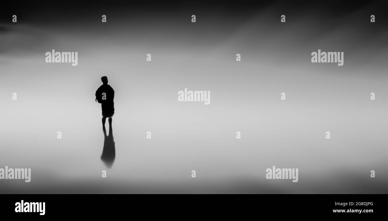 Silhouette illustration of a man standing in the space of nowhere with ...