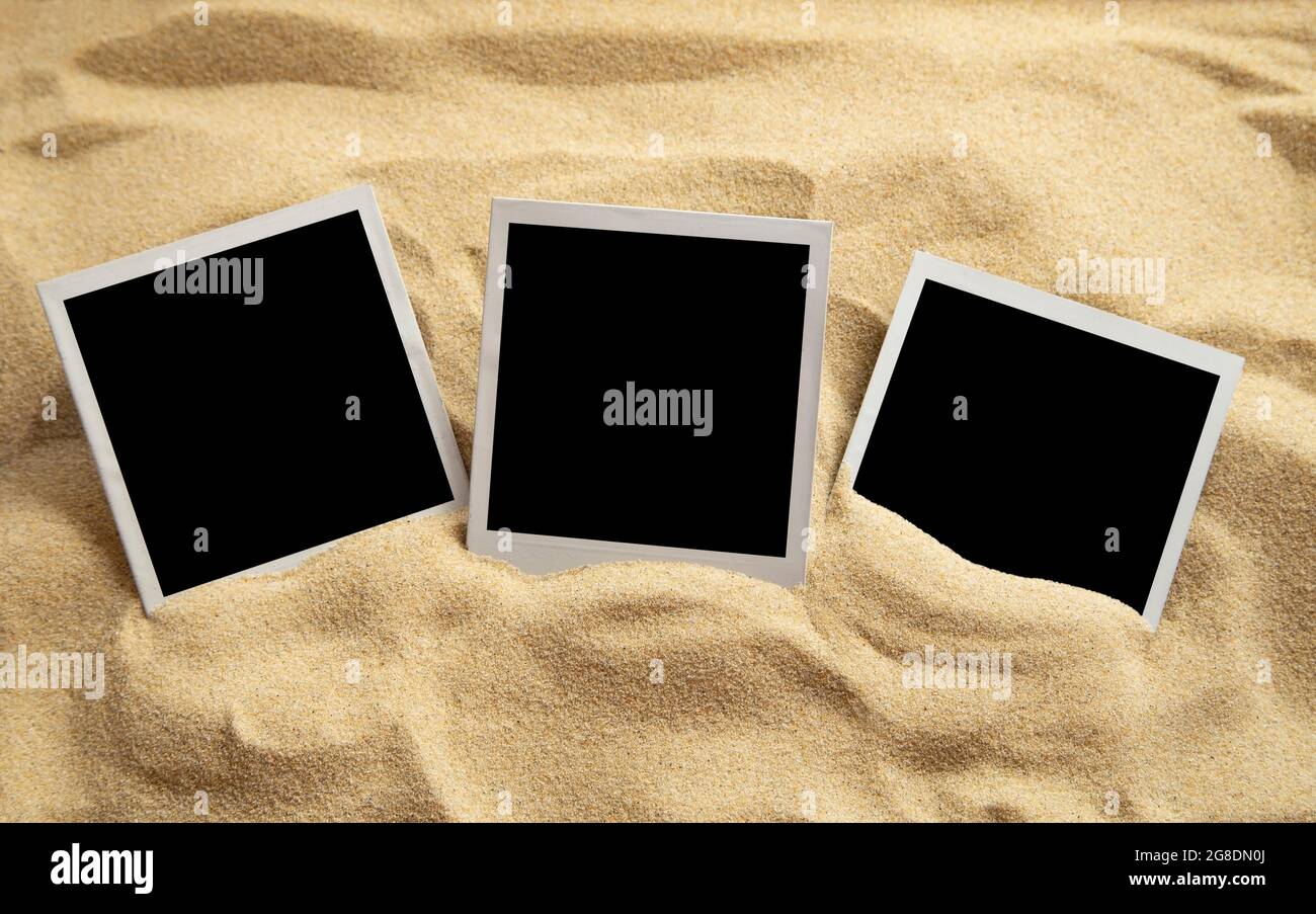 Blank instant images on sand background Stock Photo