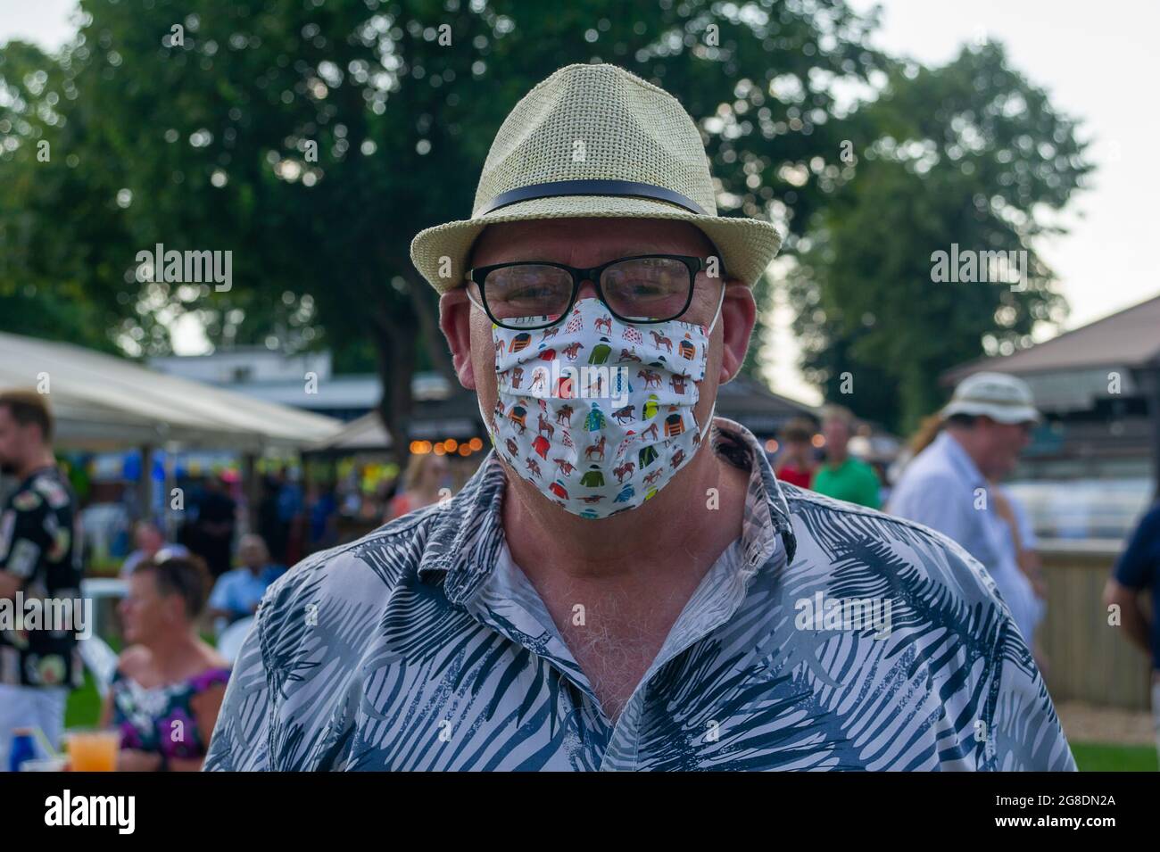 Windsor, Berkshire, UK. 19th July, 2021. A racing silks face mask of this racegoer. It was a
