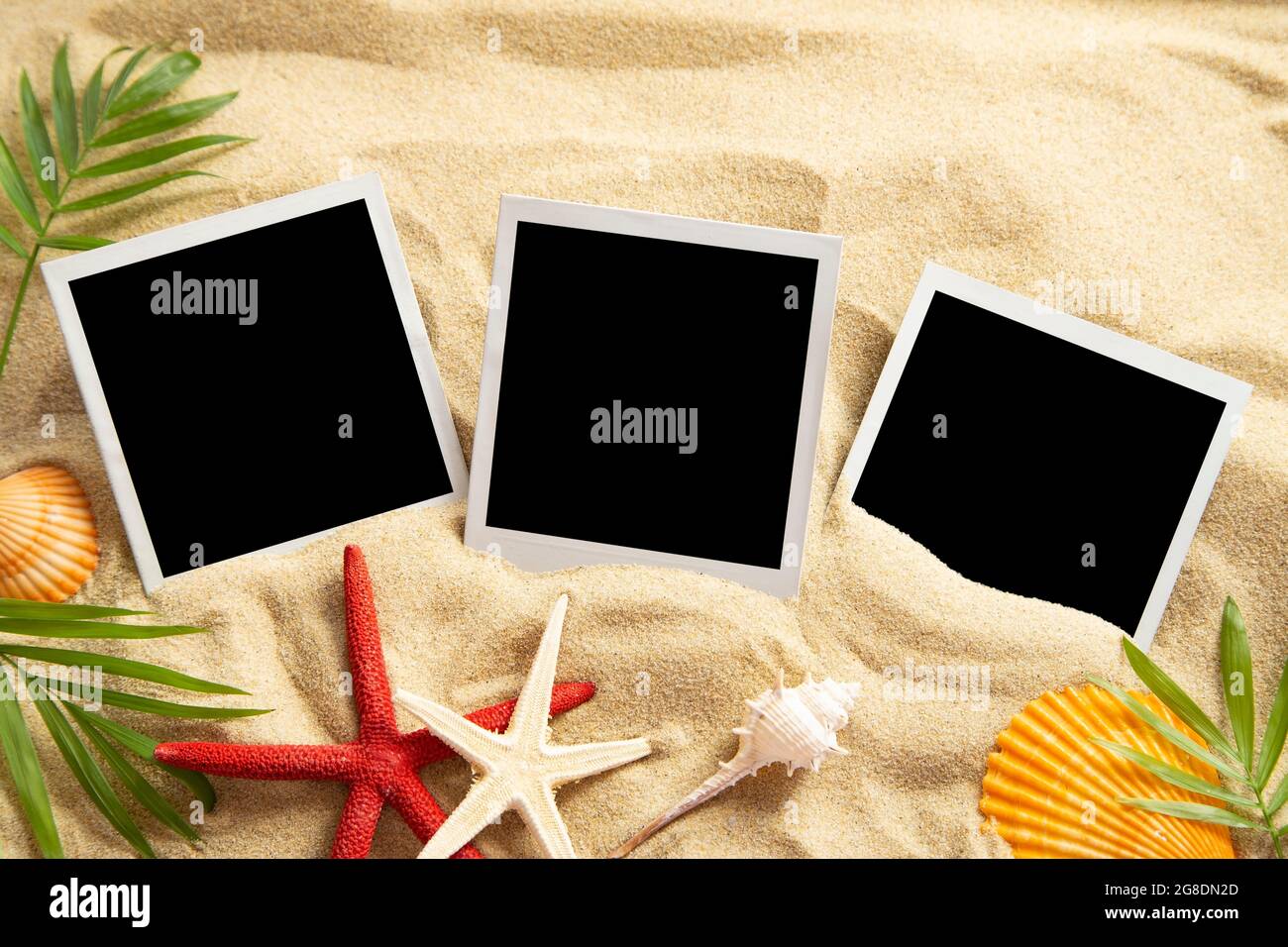 Blank instant images on sand background Stock Photo