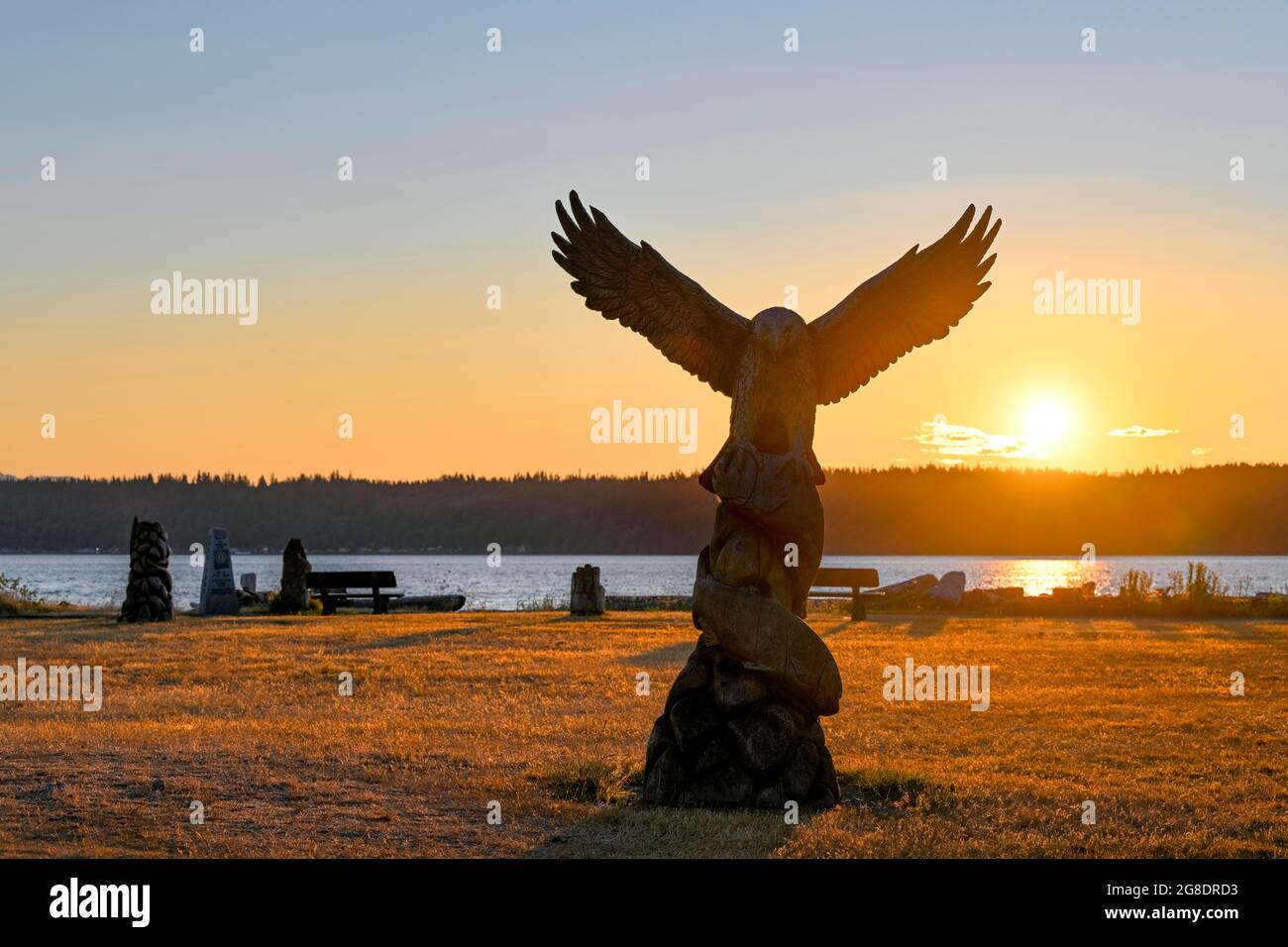 Chainsaw wood carving at sunrise, Rotary Beach Park, Campbell River