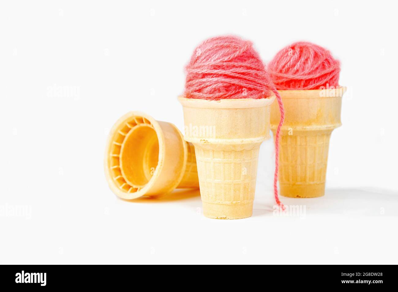 Pink yarn balls in ice cream cones isolated on white background Stock Photo