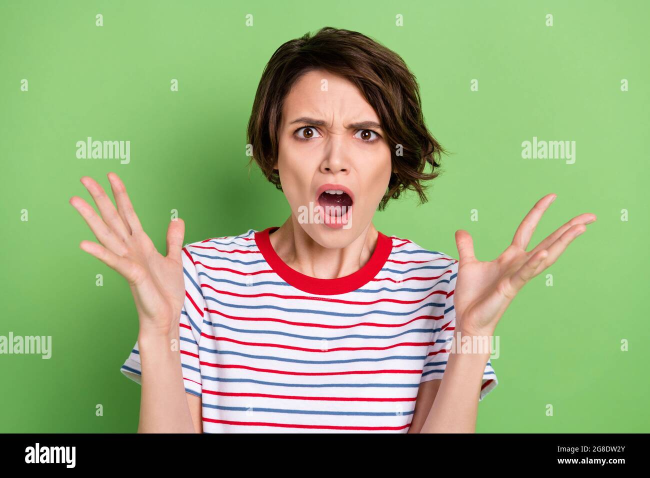 Portrait of pretty furious girl having fight saying pretense isolated over green pastel color background Stock Photo