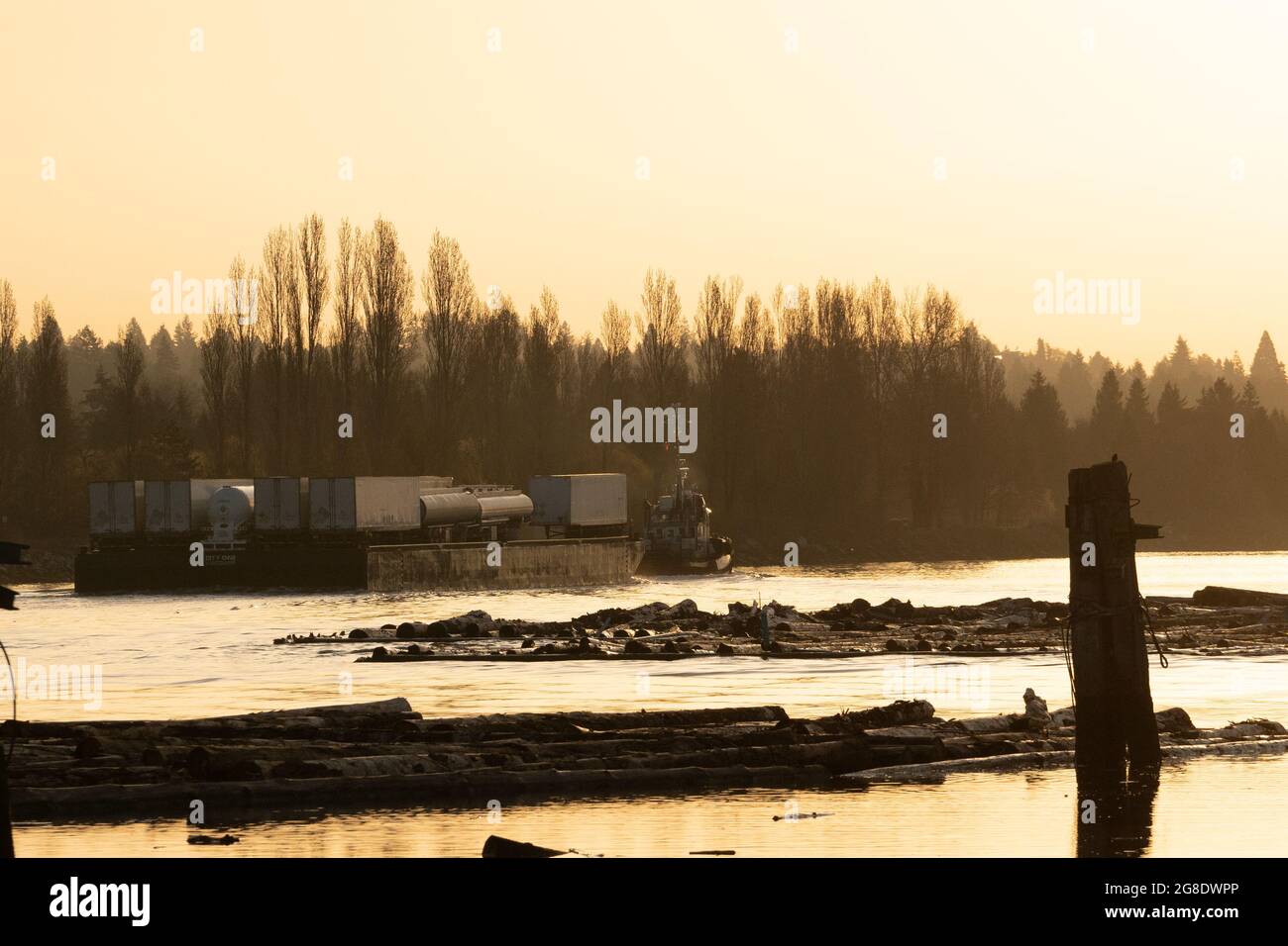 Commercial barge in the lower Fraser River. Stock Photo