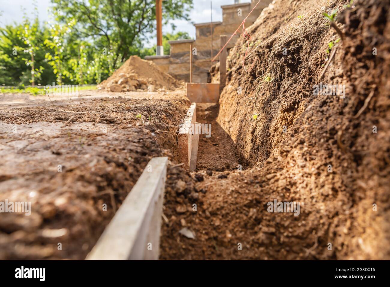 Construction planning in a garden to lay bricks to build a wall Stock Photo