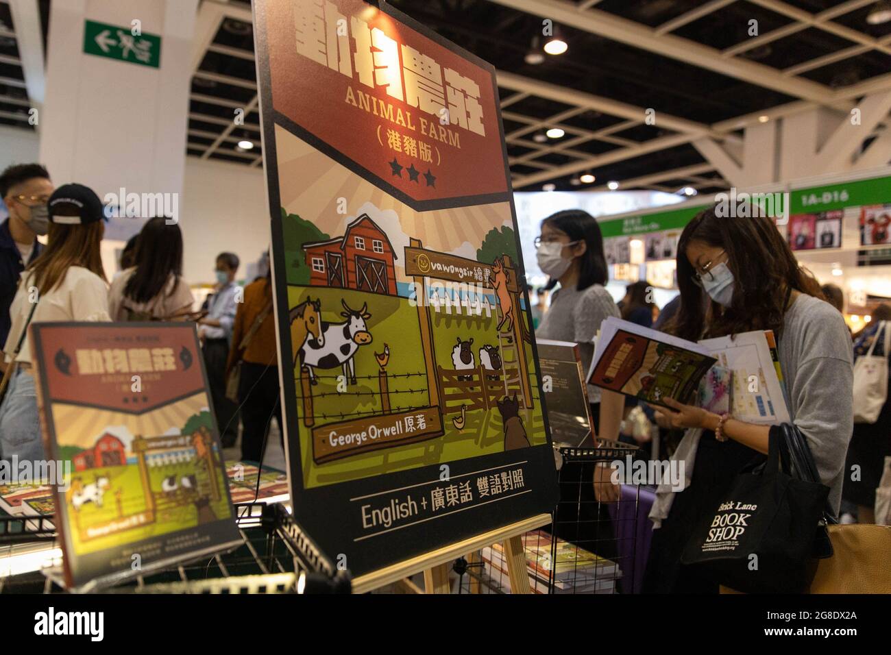 Hong Kong, Hong Kong. 19th July, 2021. A woman reads Animal Farm written by George Orwell, the book was reinterpreted by a Hong Kong writer using Cantonese to suit current social situation in Hong Kong.Amid COVID-19 pandemic and censorship due to National Security Law established last year, The Hong Kong Book Fair 2021 opened from 14-20 July however unlike previous book fairs, this year has less books about local politics. Credit: SOPA Images Limited/Alamy Live News Stock Photo