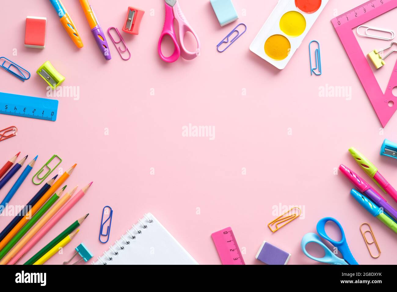 Flat lay composition with school stationery on pink background. Back to ...