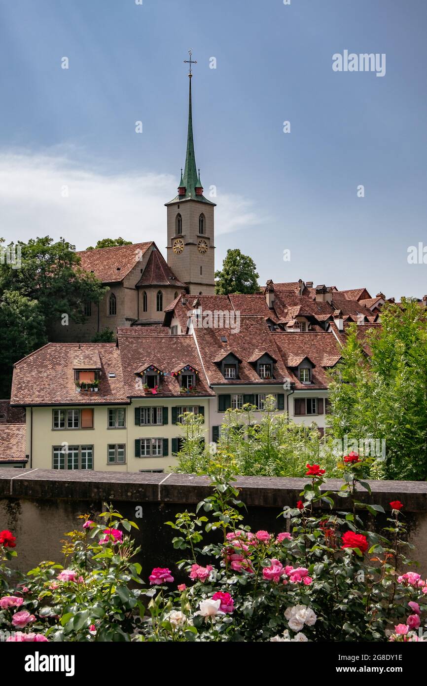 Nydeggkirche Church Tower and Traditional Timber Houses - Flowers in the Spring, Summer- City Center of Bern, Switzerland - UNESCO Heritage Stock Photo