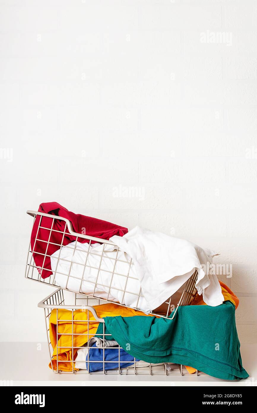 Pile of dirty, colorful laundry in baskets.  Stock Photo