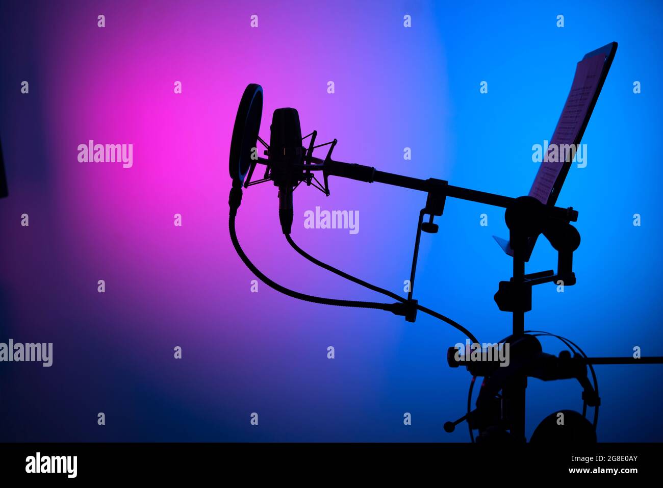 Voiceover studio large diaphragm cardioid microphone, headphones and lectern in professional