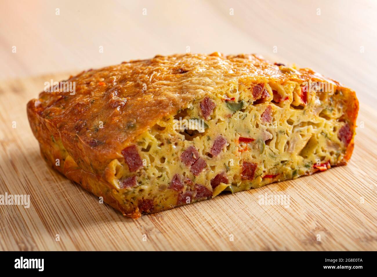 Salted cake made from eggs, cheese, olives, salami, mushrooms and red pepper Stock Photo