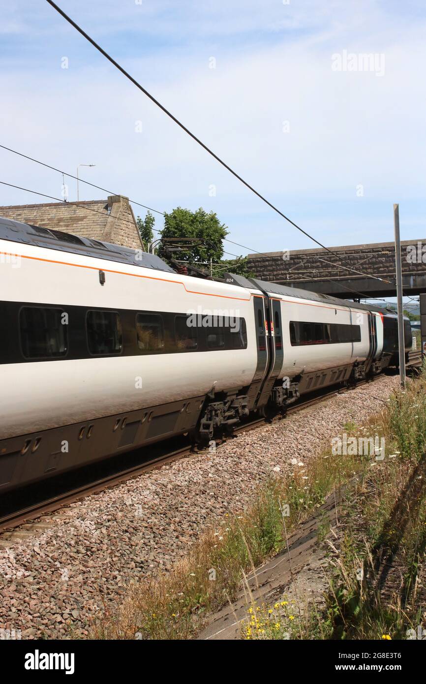 Avanti West Coast pendolino electric multiple-unit passing through Carnforth on the West Coast Main Line 19th July 2021 with Glasgow to London service. Stock Photo