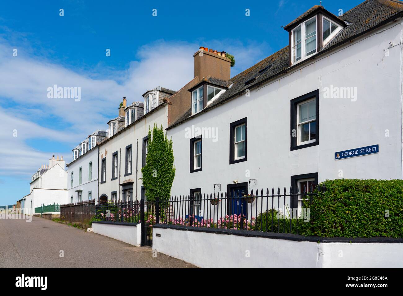 Whitewashed terraced houses in Cromarty village on Black Isle on