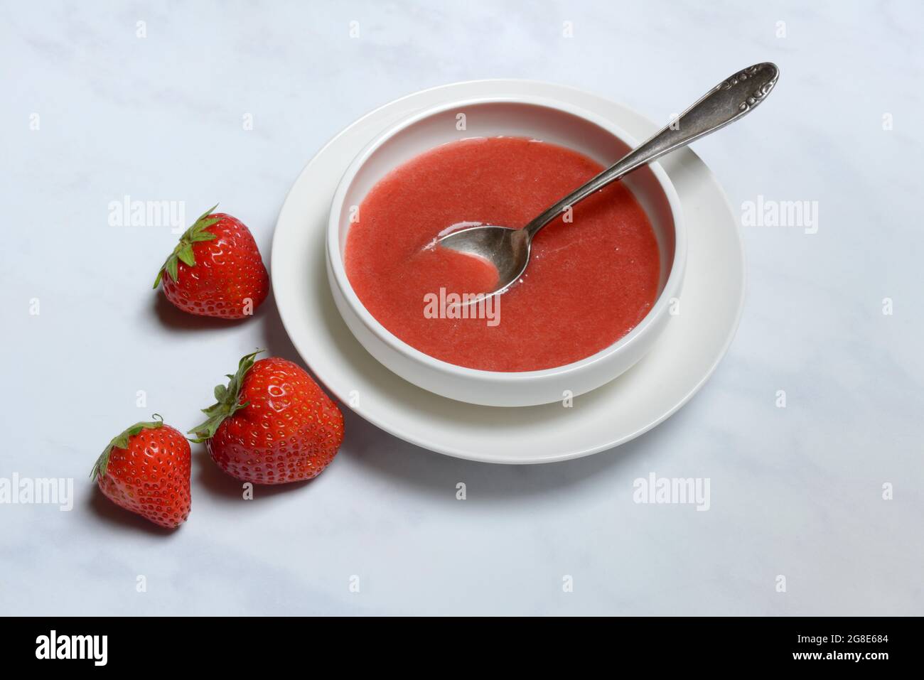 Strawberry sauce in bowl and strawberries, Germany Stock Photo Alamy