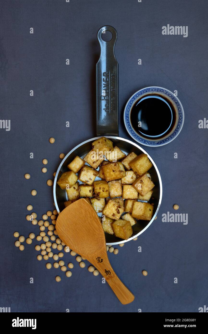 Fried tofu cubes in pan and soy sauce, Germany Stock Photo Alamy