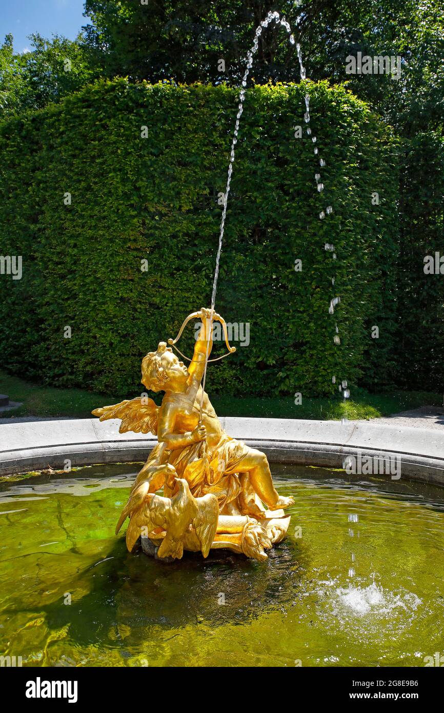Fountain figure love god Cupid with bow and arrow, east parterre, castle park, Linderhof Castle, Upper Bavaria, Bavaria Stock Photo