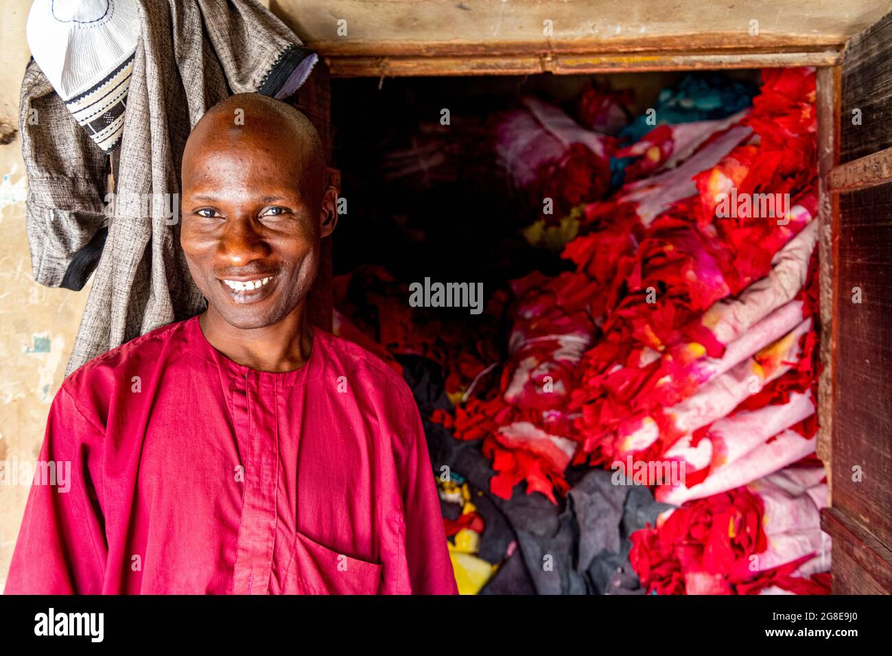 Shopkeeper before his shop full of colourful leather, Kano, Kano state, Nigeria Stock Photo