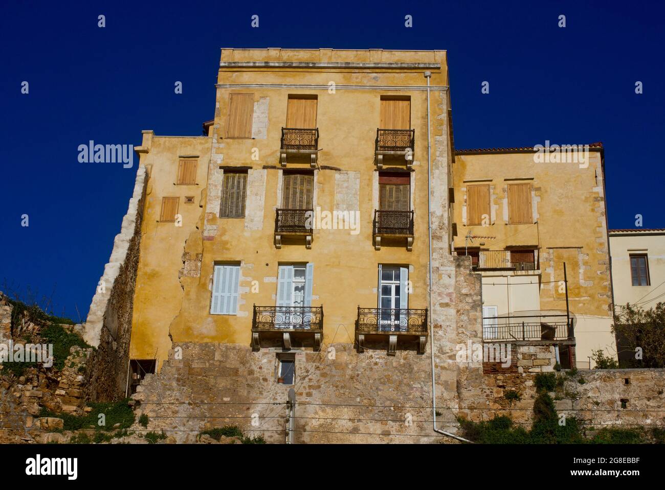 Facade of an old building on Chania's harbour promenade on the island of Crete, Greece Stock Photo