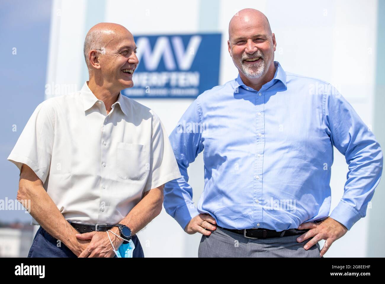 Wismar, Germany. 14th July, 2021. Carsten Haake (r), Managing Director Finance and Administration at MV Werften and Peter Fetten (l), Managing Director of MV Werften, stand in front of the shipbuilding hall. The incipient recovery of the international cruise market is also raising hopes of recovery at the MV Werften Group. Currently, the company is concentrating on the completion of the 'Global Dream'. Delivery of the 342-meter-long, 20-deck-high ship is scheduled for mid-2022. Credit: Jens Büttner/dpa-Zentralbild/dpa/Alamy Live News Stock Photo