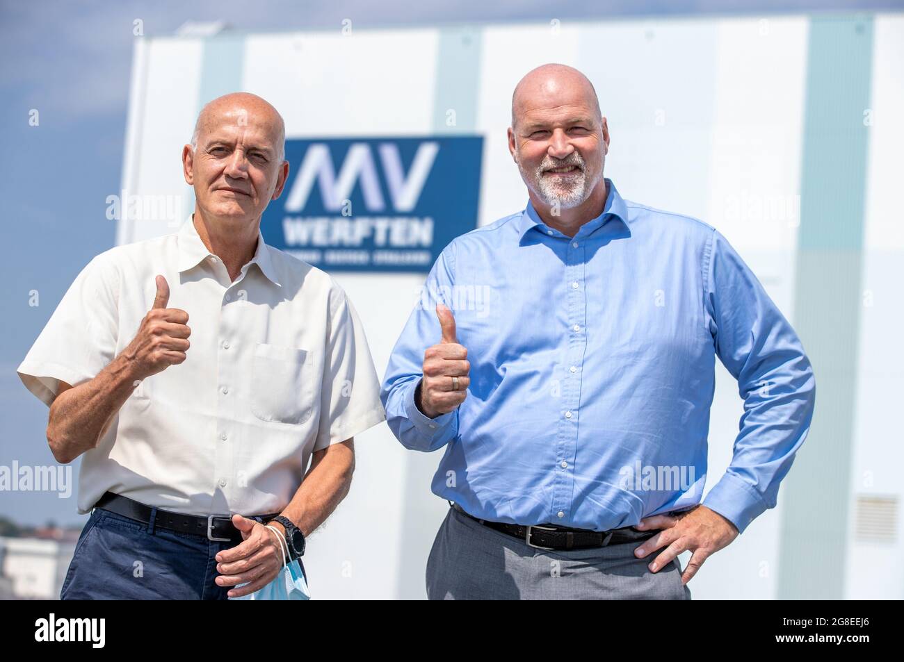 Wismar, Germany. 14th July, 2021. Carsten Haake (r), Managing Director Finance and Administration at MV Werften and Peter Fetten (l), Managing Director of MV Werften, stand in front of the shipbuilding hall. The incipient recovery of the international cruise market is also raising hopes of recovery at the MV Werften Group. Currently, the company is concentrating on the completion of the 'Global Dream'. Delivery of the 342-meter-long, 20-deck-high ship is scheduled for mid-2022. Credit: Jens Büttner/dpa-Zentralbild/dpa/Alamy Live News Stock Photo