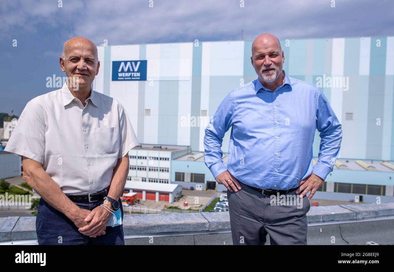 Wismar, Germany. 14th July, 2021. Carsten Haake (r), Managing Director Finance and Administration at MV Werften and Peter Fetten (l), Managing Director of MV Werften, stand in front of the shipbuilding hall. The incipient recovery of the international cruise market is also raising hopes of recovery at the MV Werften Group. Currently, the company is concentrating on the completion of the 'Global Dream'. Delivery of the 342-meter-long, 20-deck-high ship is scheduled for mid-2022. Credit: Jens Büttner/dpa-Zentralbild/dpa/Alamy Live News Stock Photo